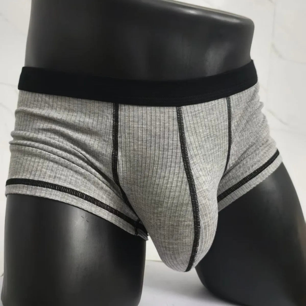 Men's solid colour breathable boxer shorts on a white background showing hip lifting design.