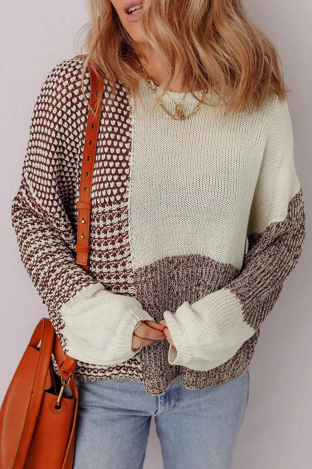 Dark khaki colour-block loose sweater with a back tie and drop shoulders on a hanger.