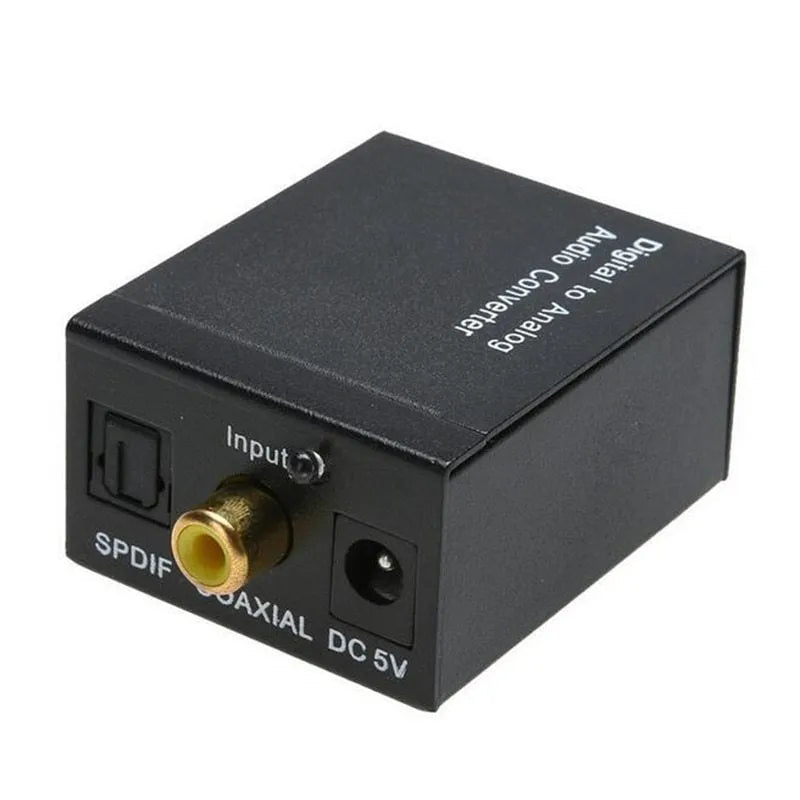 Black digital to analogue audio converter with optical cable and power supply