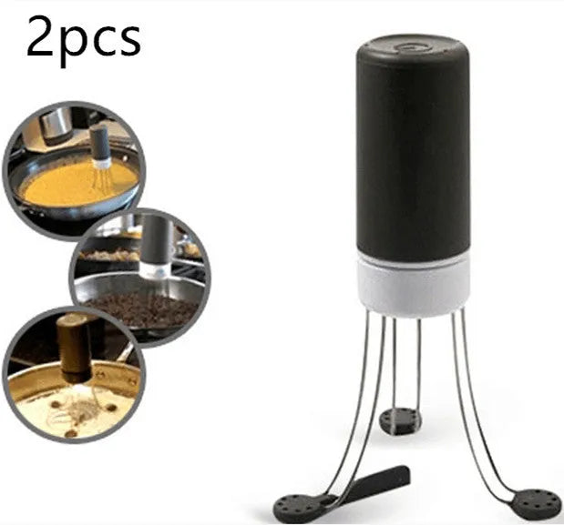 White and black automatic kitchen food stirrer with stainless steel whisk on countertop.