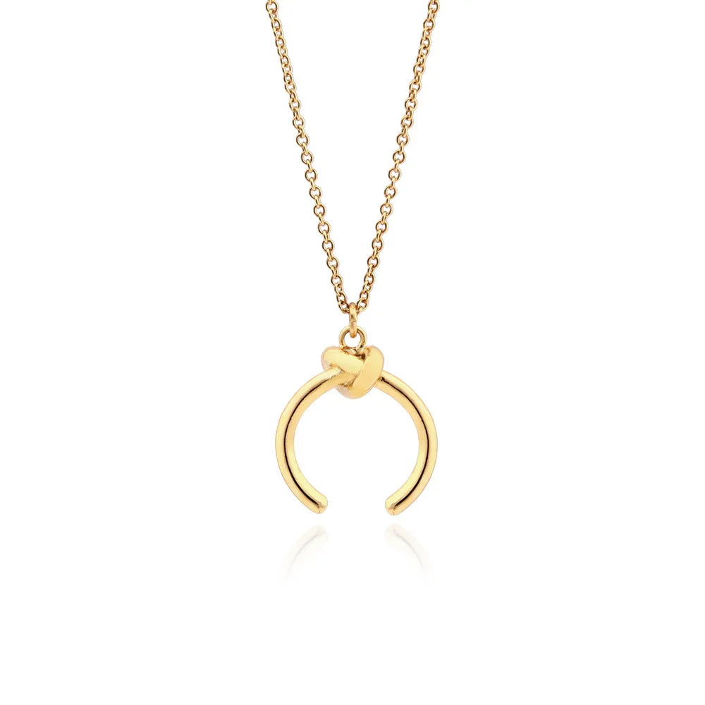 Vintage-style geometric copper pendant necklace on an adjustable cross chain in gold colour.