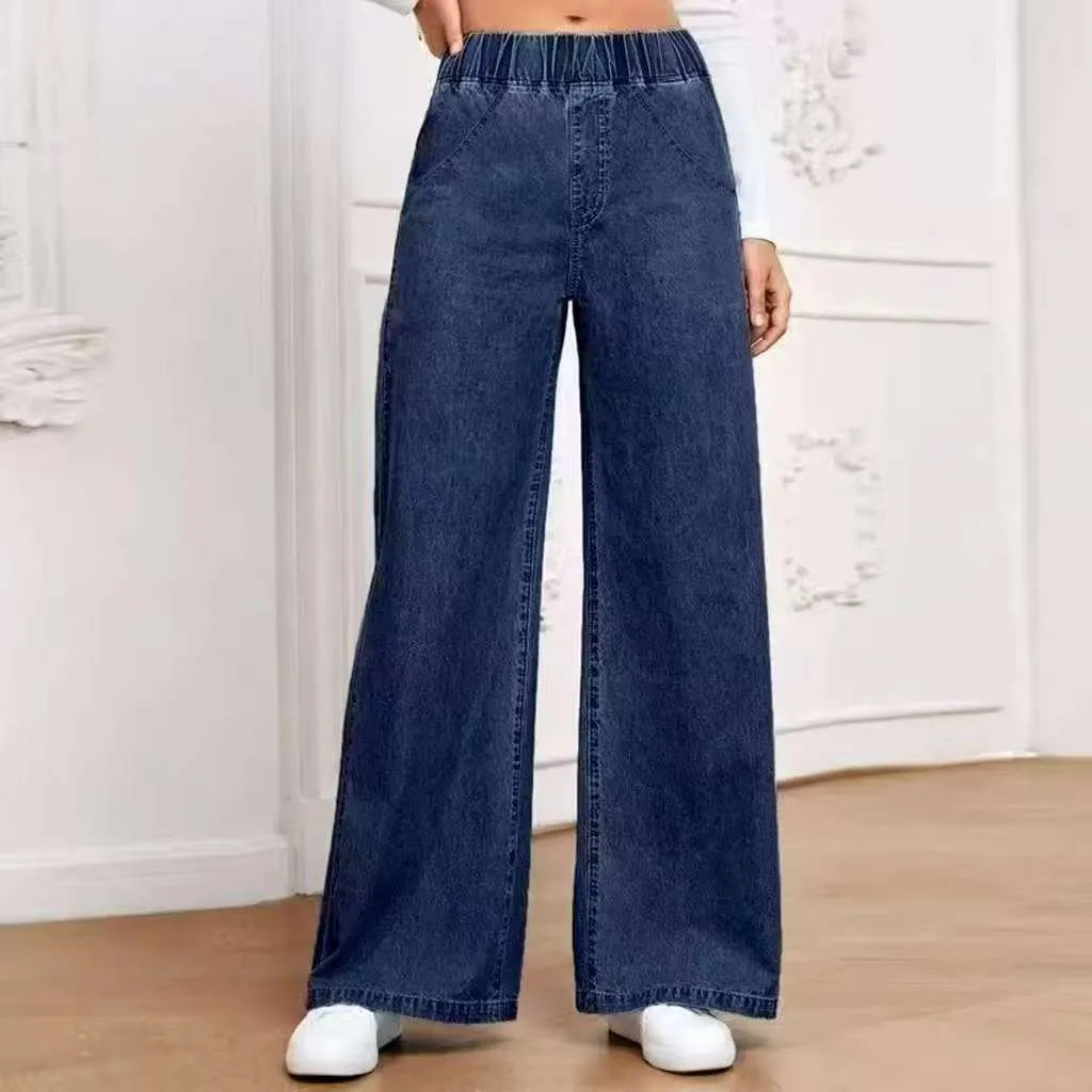 Light blue washed plus size women's wide-leg straight jeans on a mid-waist fit.