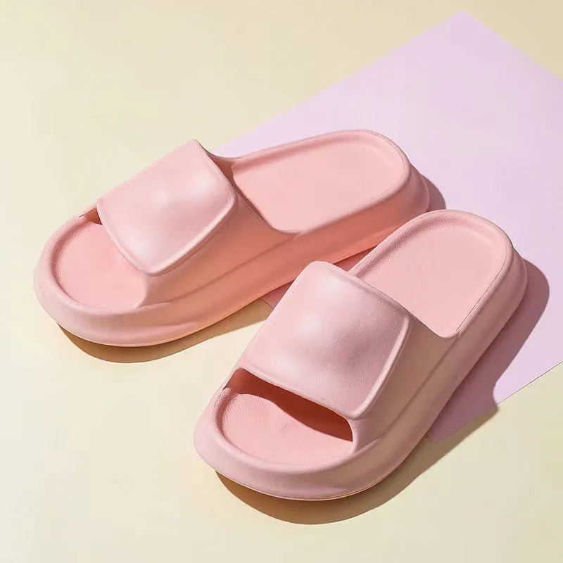 A pair of thick-soled EVA flip-flop slippers on a bathroom floor, showcasing non-slip tread and available colour options.