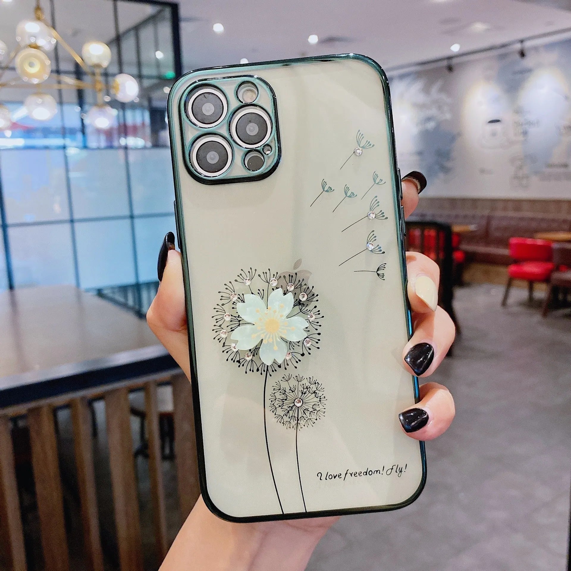 Green iPhone case with 3D floral design and extended kickstand on a table