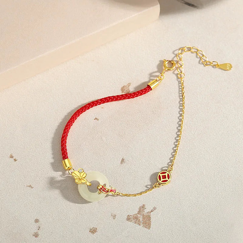 Gold-colour Koi fish charm bracelet in 925 silver with a red rope and peace buckle safety clasp.