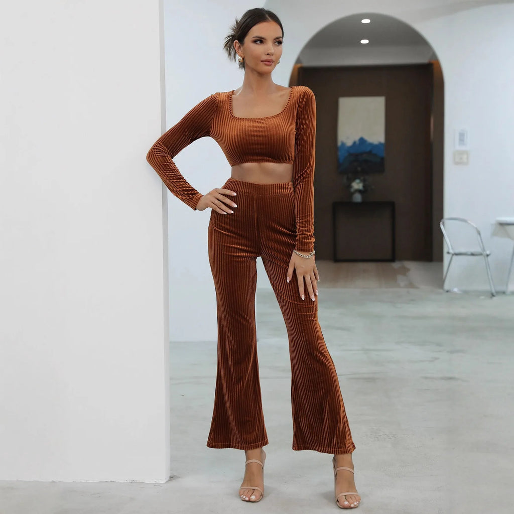Caramel coloured long sleeve sweater and straight-leg trousers set on a hanger