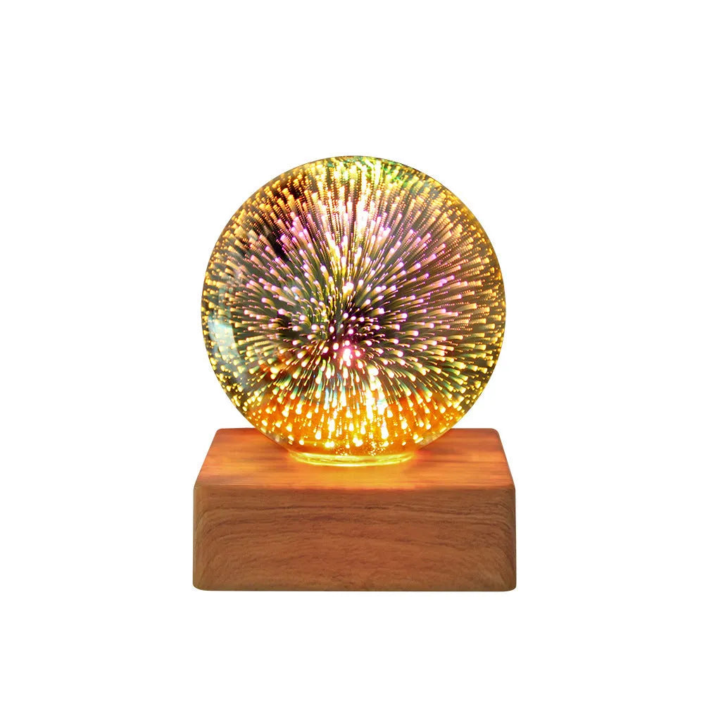 USB plug-in crystal ball LED night light showing fireworks design on a desk