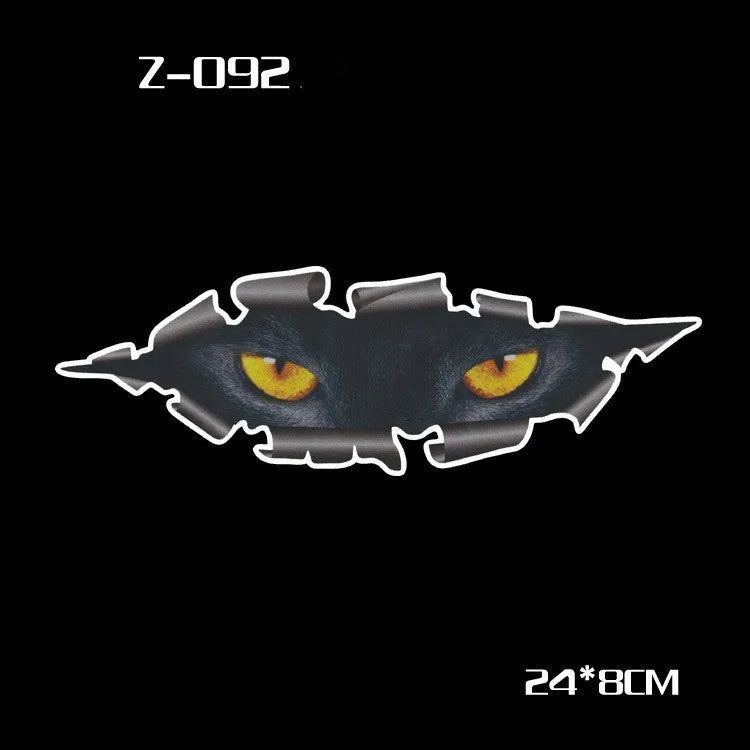 Pair of reflective cartoon car stickers with cute eyes on a car rearview mirror.
