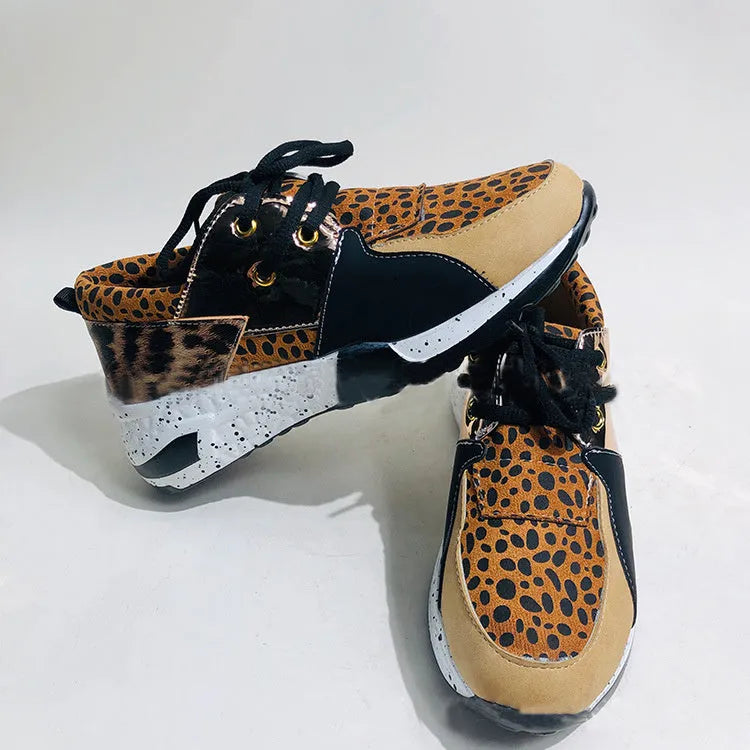 Women's casual suede wedge sneakers in leopard print with a low-cut design and plastic sole.