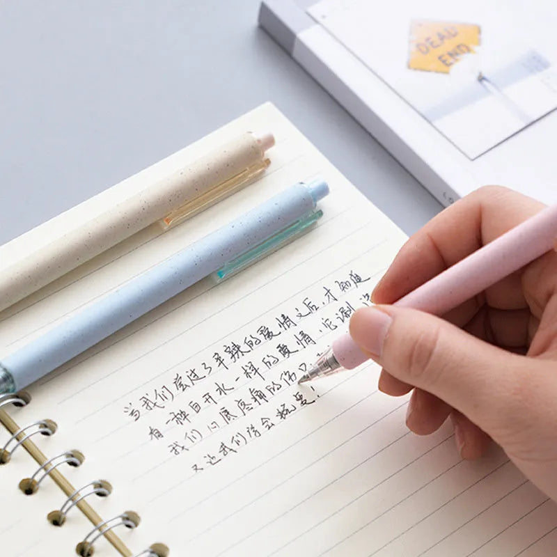 Set of 12 push-type 0.5mm gel pens in beige, blue, green, and pink colours on a white background