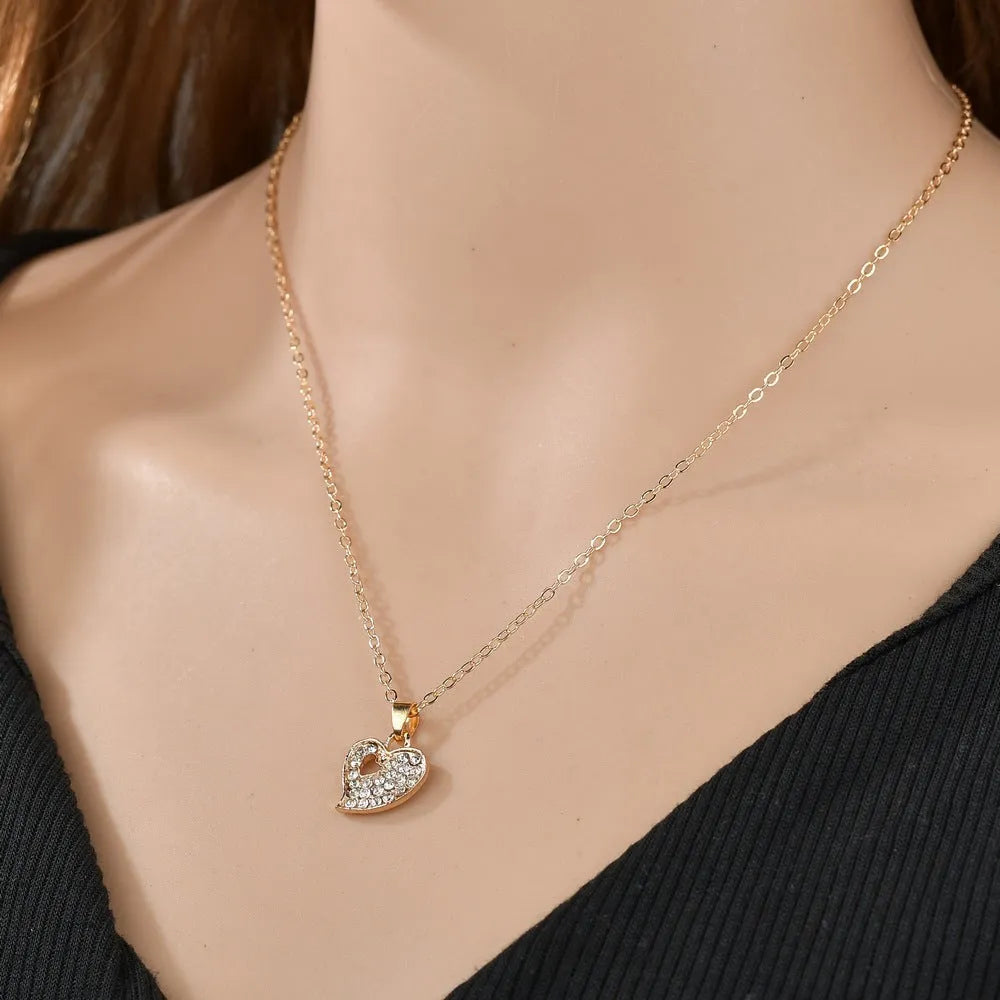 Women's gold electroplated jewellery set with earrings, pendant, and hand decoration featuring love, water drop, and bell patterns