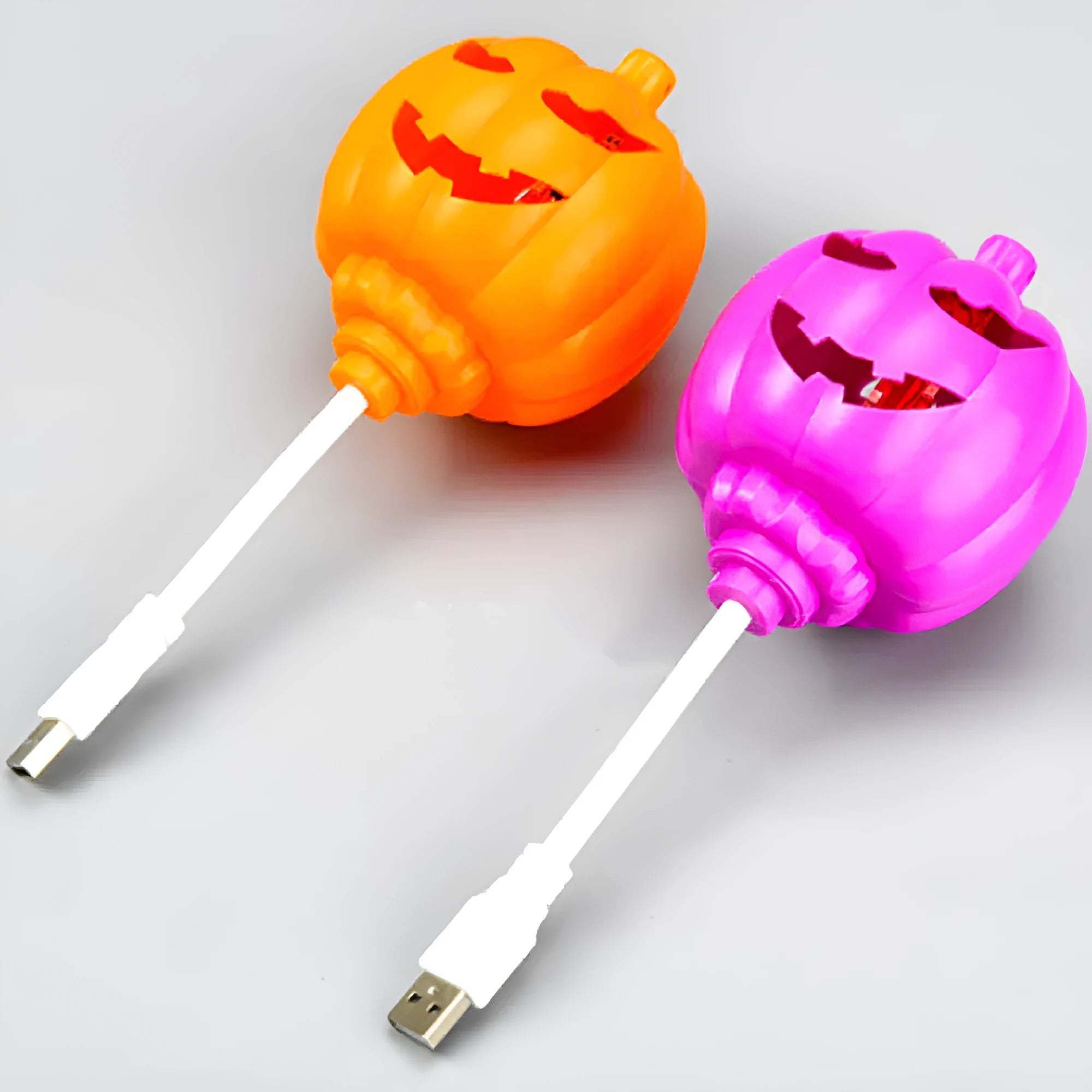 Plastic pumpkin-shaped decorative lamp with USB cable, showing yellow or purple LED light option.
