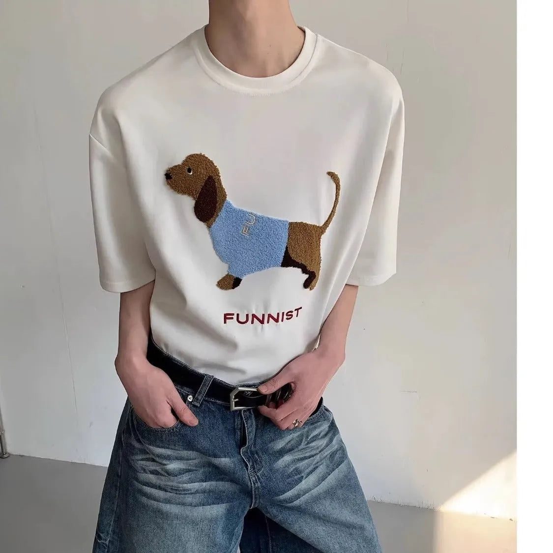 Men's gray cotton t-shirt with an embroidered cartoon sausage dog holding a blue towel.