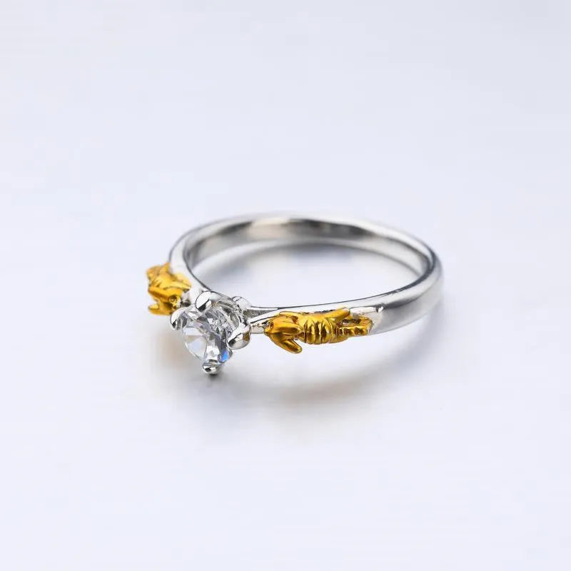 Close-up of a black gold finished copper ring with a detailed 1.5cm tall crown model on a person's finger.