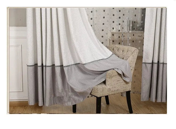 A simple blackout curtain panel hanging on a pole, demonstrating one of the hook, Korean hook, or ring attachment styles.