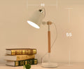 Bamboo Nordic desk lamp with touch switch and wireless charging pad in white finish on a bedside table