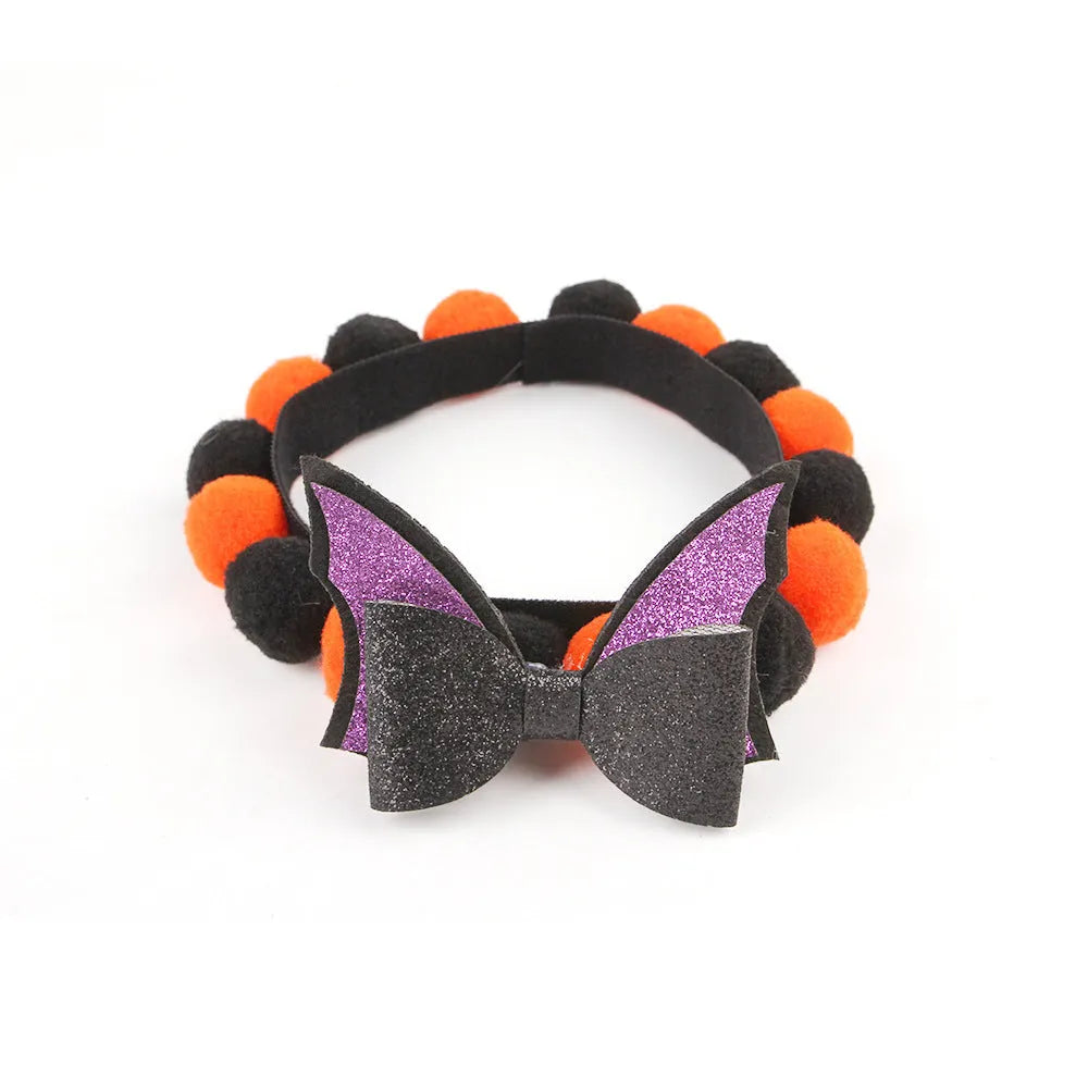 Halloween pet collar with fur ball decoration in pumpkin design on dog neck