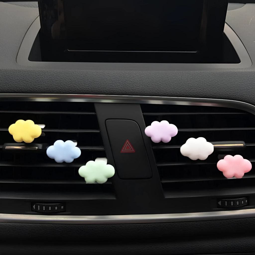 Resin cartoon car fragrance clip in pastel colours on a car air vent.