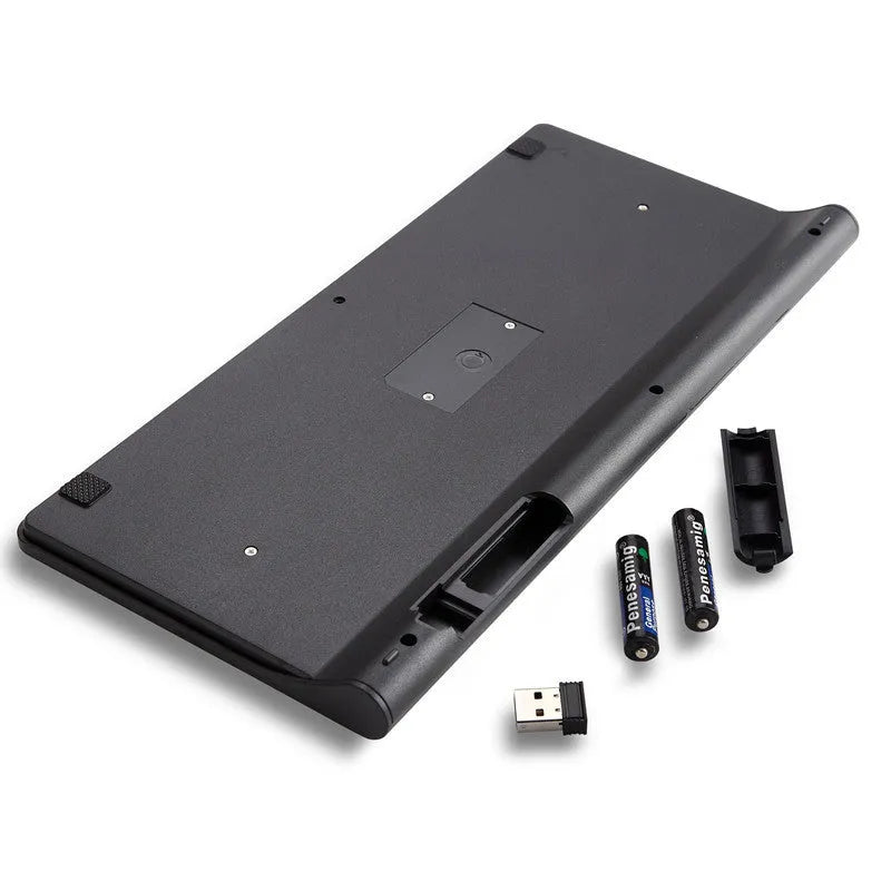 Black wireless keyboard and mouse set with USB receiver on wooden desk