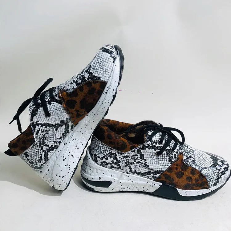 Women's casual suede wedge sneakers in leopard print with a low-cut design and plastic sole.