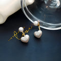 Women's heart-shaped pearl stud earrings with Korean style design and electroplated alloy construction