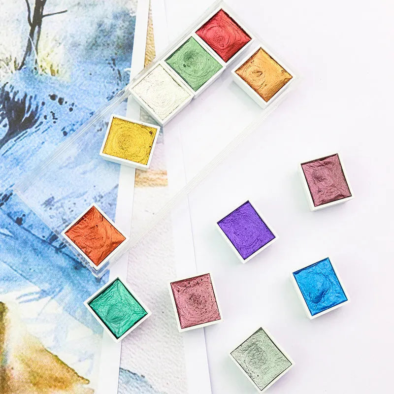 Boxed set of solid watercolour pigment blocks in pearlescent colours on a white background.
