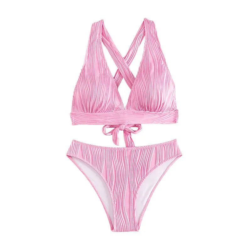 Women's pink halter strap bikini top and matching shorts on a neutral background.