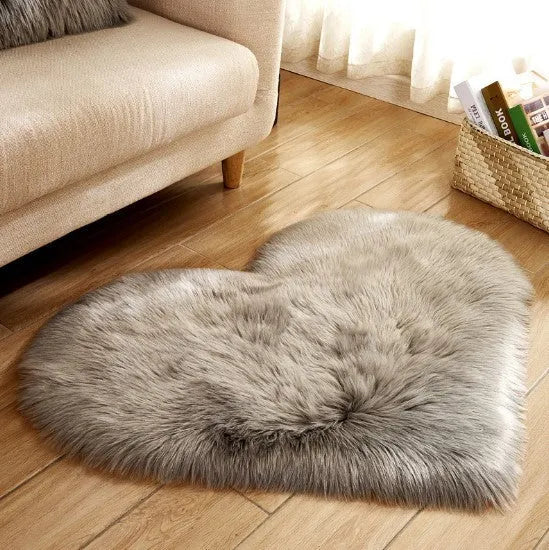 Heart-shaped plush carpet in multiple colours showing wool-like texture with 5-6 cm pile length