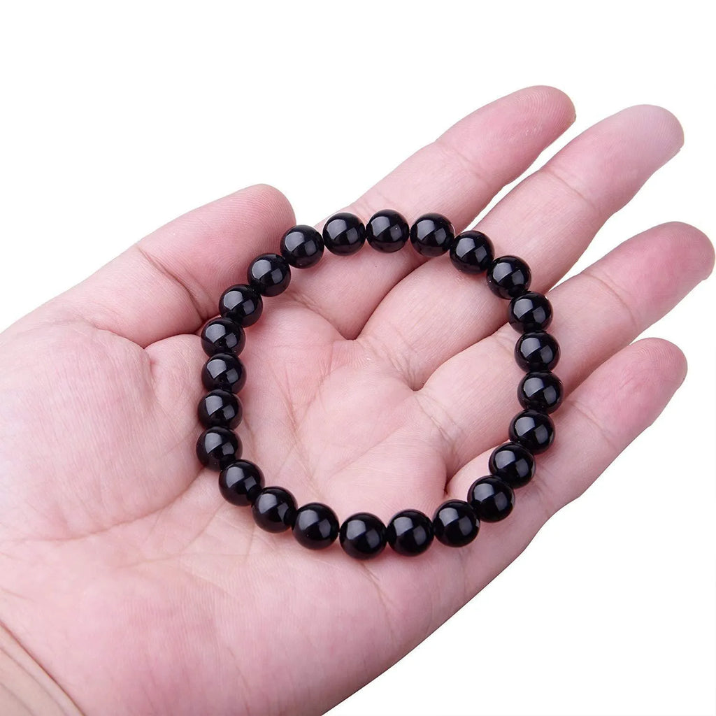 Geometric black onyx stretch bracelet with 8mm agate beads on an elastic cord.