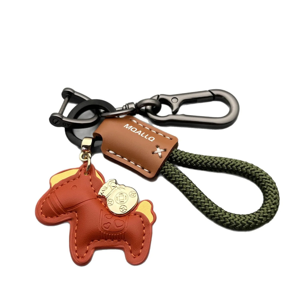 Handmade brown cowhide leather key ring with a zinc alloy pendant charm on a green flannel rope.