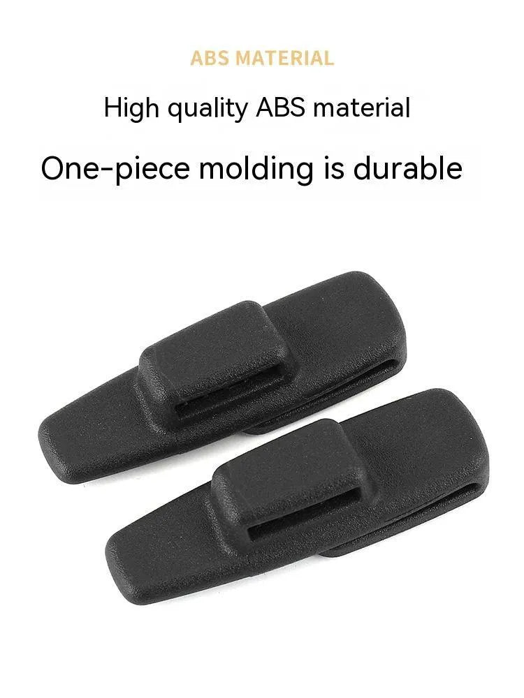 Two black ABS plastic car seatbelt adjustment clips packaged in a clear OPP bag.