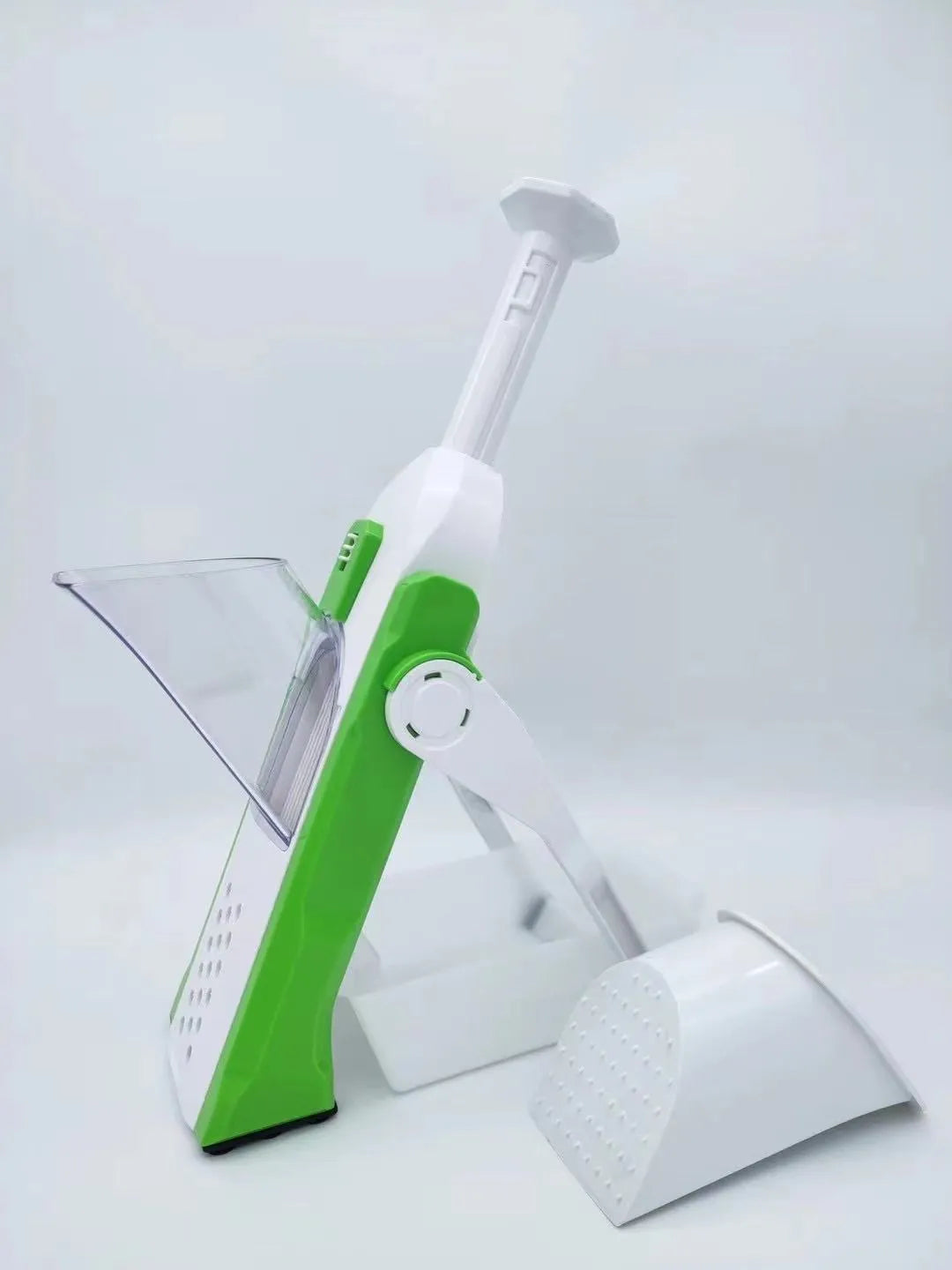 White and blue multifunctional vegetable slicer with stainless steel blades on a kitchen counter.