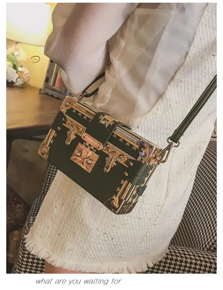 Women's black structured PU leather flap shoulder bag with cross-body strap and rivet details.