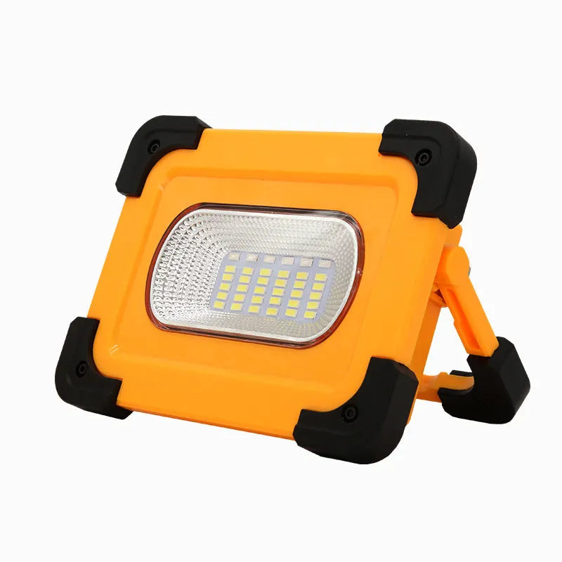 Yellow outdoor portable solar LED light with power bank and magnetic base, 36LED lamp beads model 5730, sitting on a metal surface