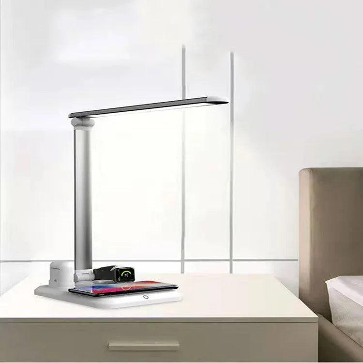 Black and white 4-in-1 LED desk lamp with wireless charging pad, Bluetooth speaker, and digital clock display.