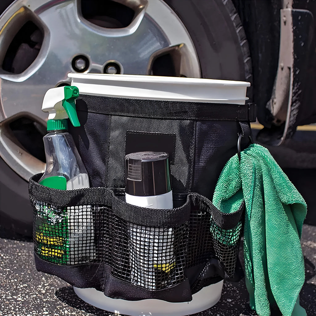 Black cylindrical polyester buggy storage bag hanging from a 5-gallon barrel.