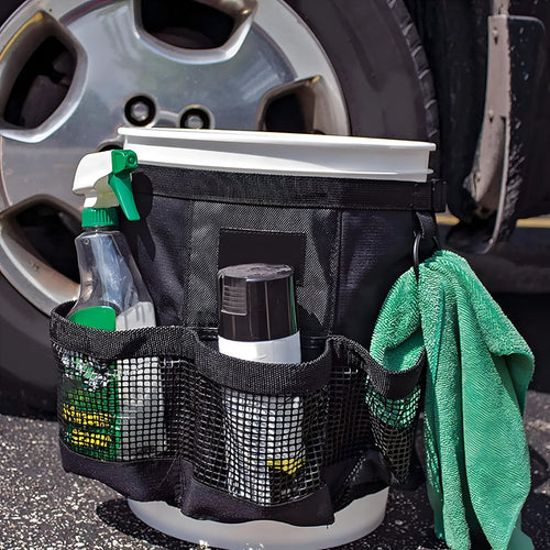 Black cylindrical polyester buggy storage bag hanging from a 5-gallon barrel.