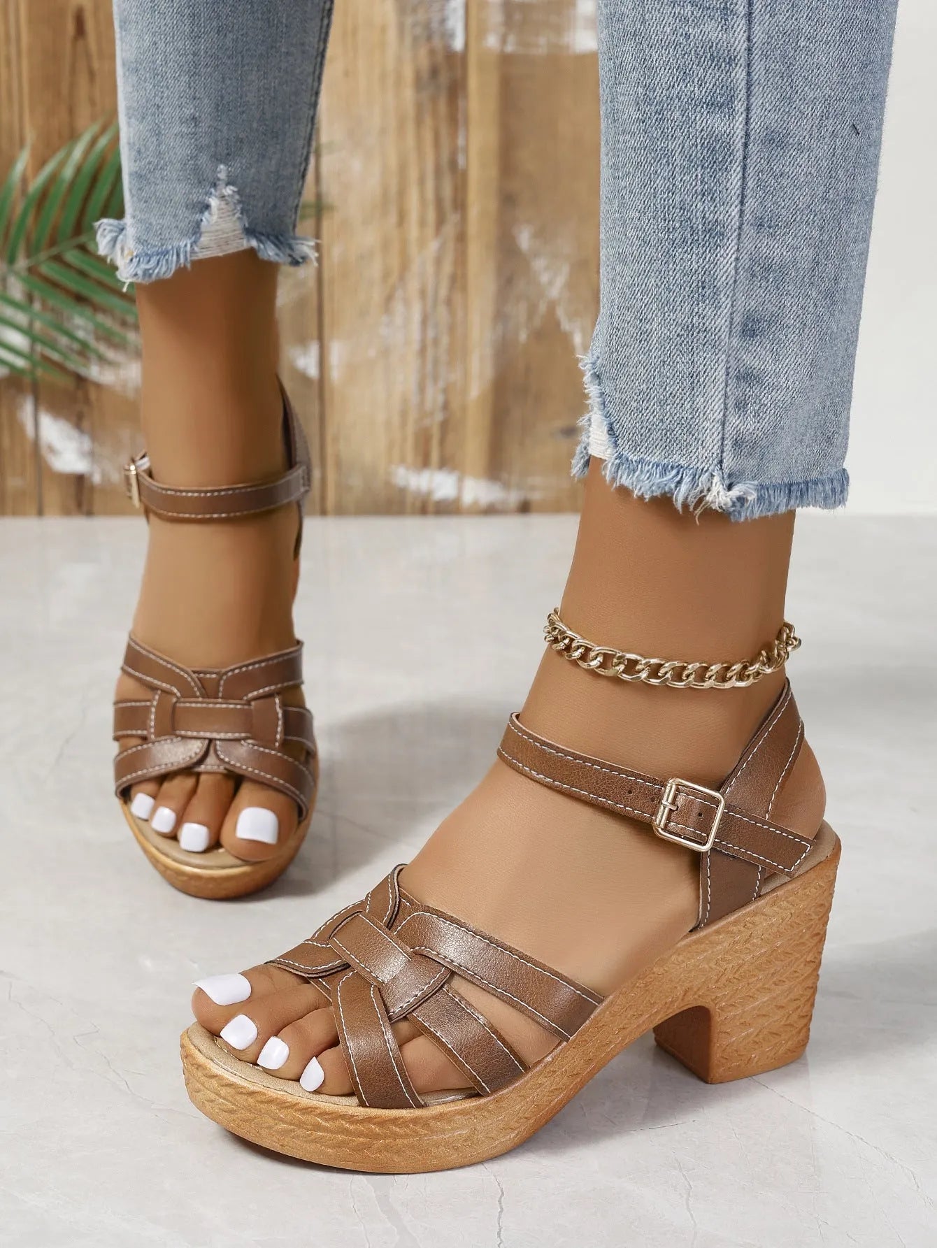 Plus size women's black peep toe sandals with chunky heel and ankle-strap buckle.