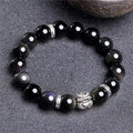 Obsidian bracelet with silver 999 settings showing natural cloud patterns in the beads