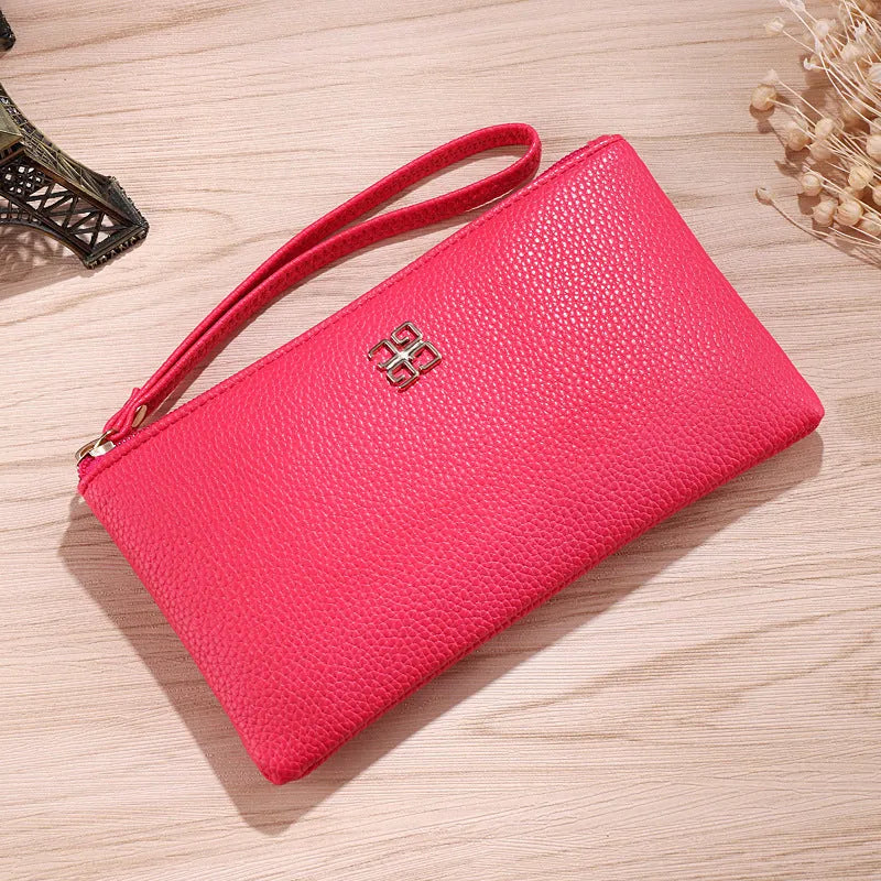 Long slim wine red PU leather wallet handbag with a top zip, shown open to reveal card slots and a phone pocket.
