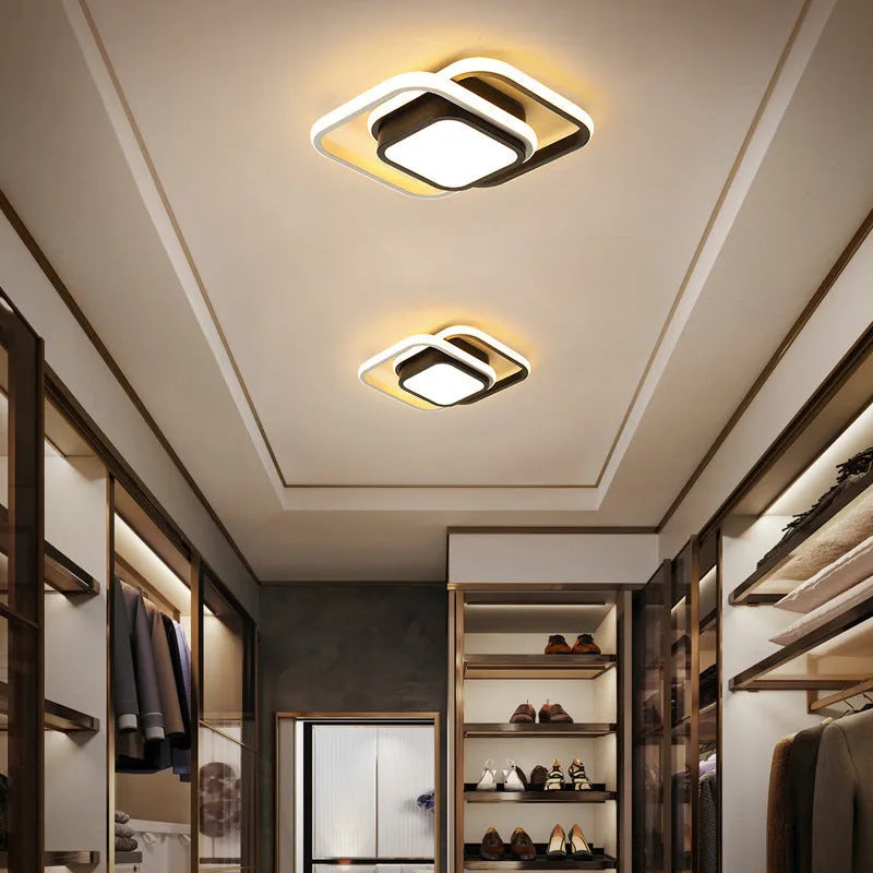 Modern round aluminium ceiling light with integrated LEDs, shown illuminating an entrance hall.
