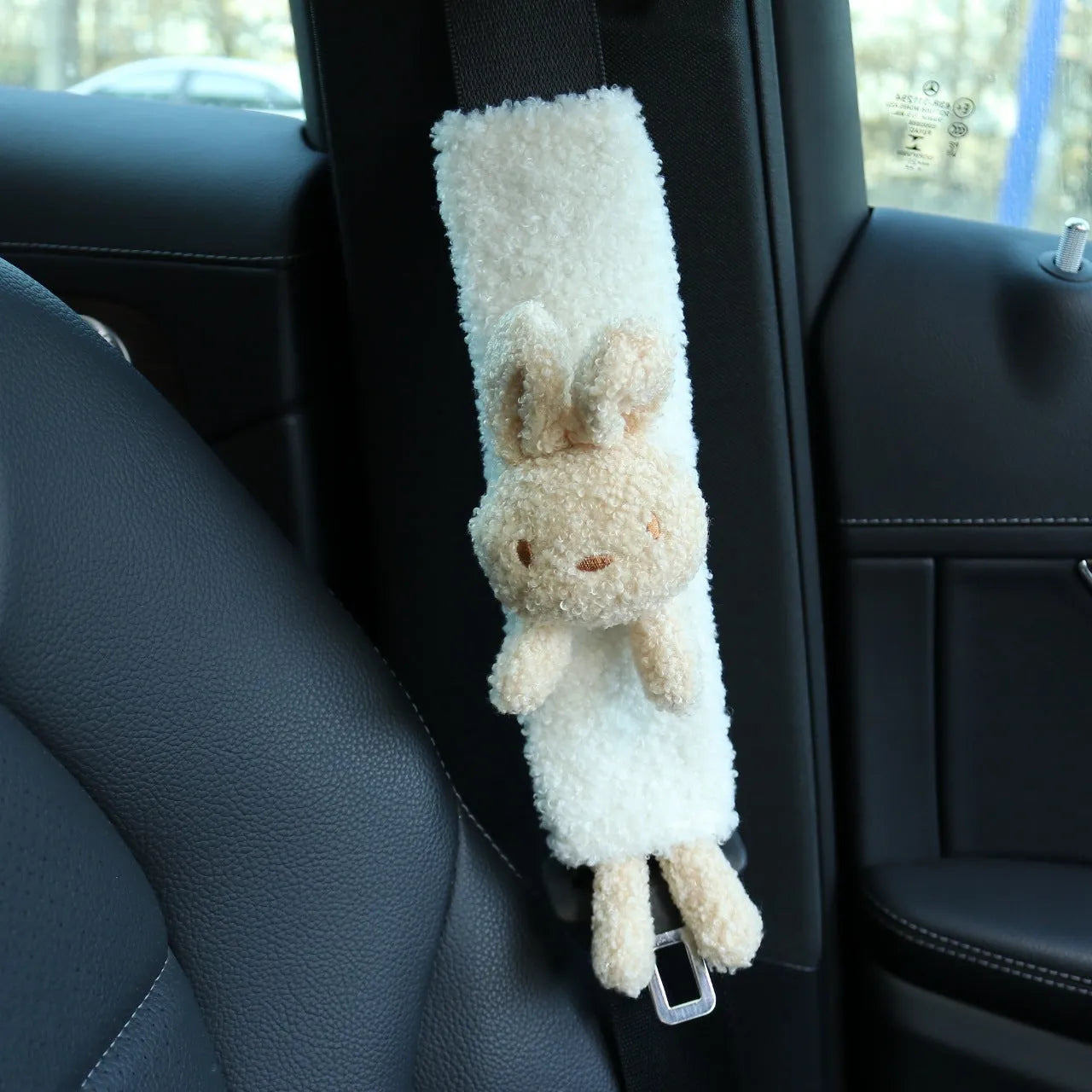 Cartoon plush seat belt shoulder protector in lamb wool with bear and rabbit designs.