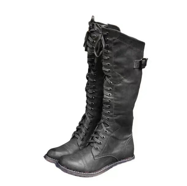 Women's black chunky heel high leg boots with a round toe and low profile.