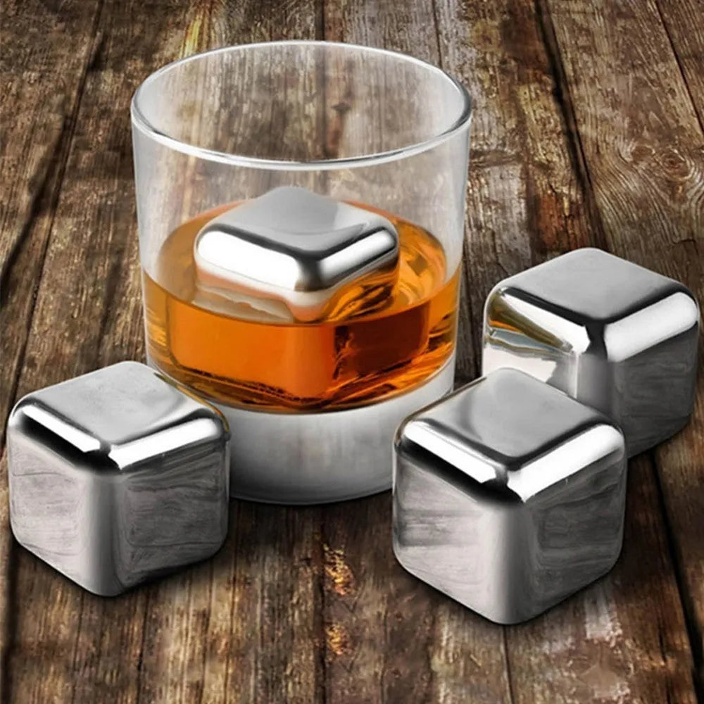 Set of eight stainless steel whiskey chilling stones and metal clip in storage box.