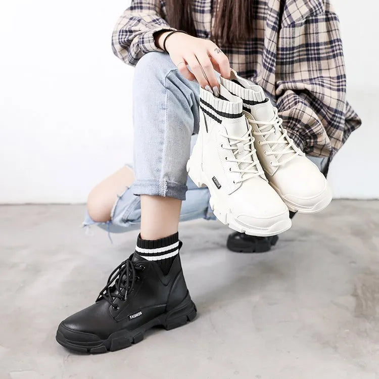 Women's short Martin boots in black faux PU leather with decorative stitching and lace-up front