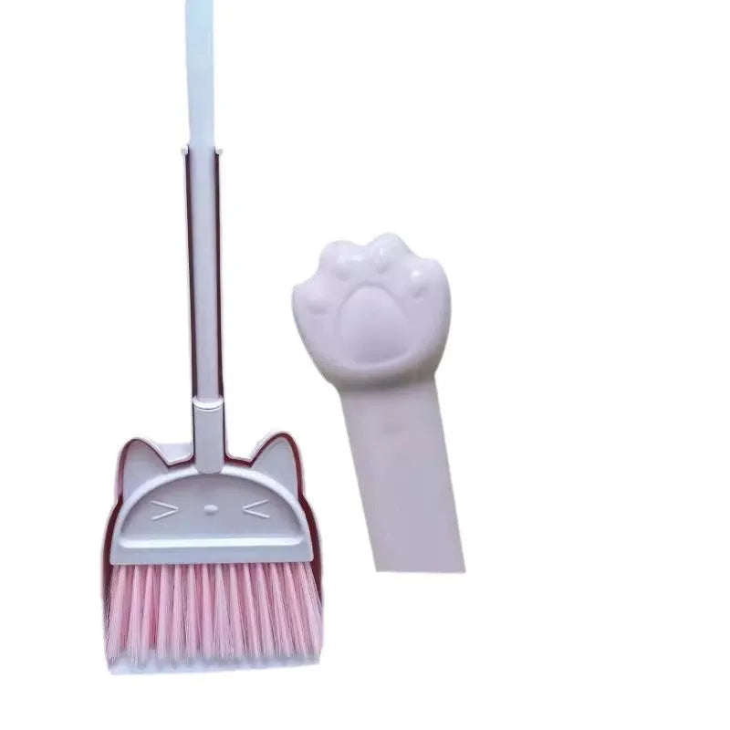 Purple plastic broom and dustpan set with a rotating brush holder on a wooden floor.