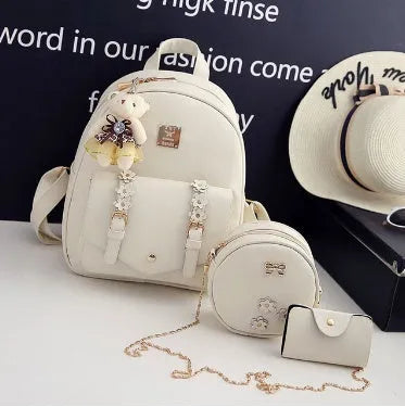 Women's three-piece leather bag set with floral embroidery including backpack, shoulder bag and card holder