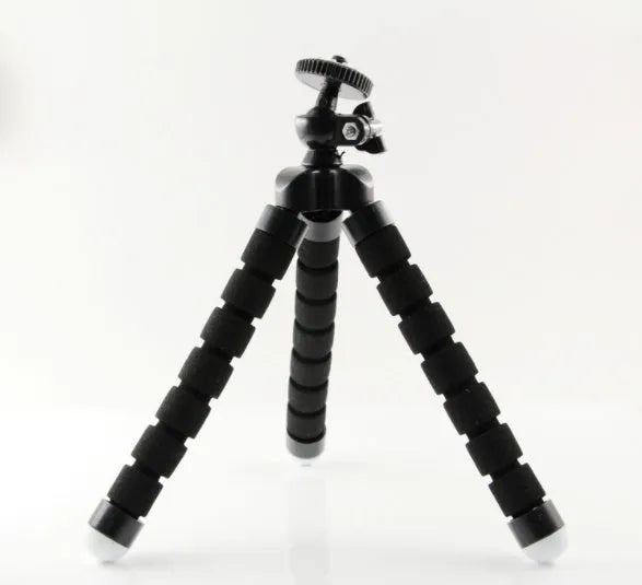 Black flexible octopus tripod with bent legs wrapped around a pole, showing a smartphone attached.