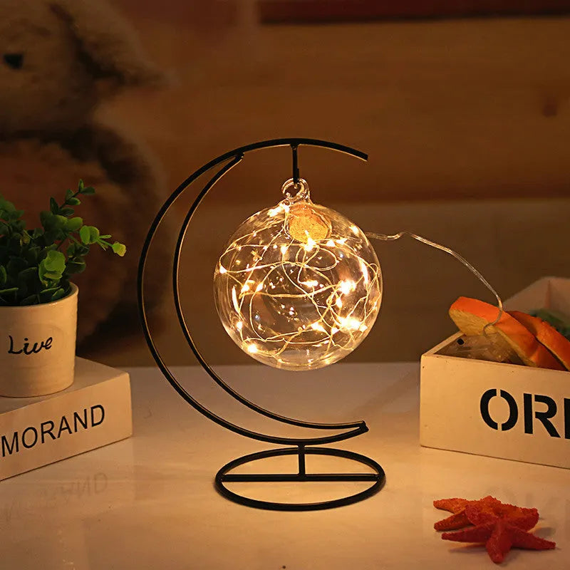 Round glass wish bottle with cork, 12 cm diameter, containing a warm white LED light strand with 20 lamp beads and folded paper stars