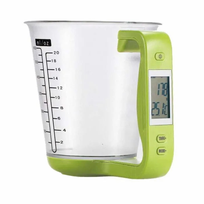 Green digital kitchen scale measuring cup with LCD display in handle on kitchen counter